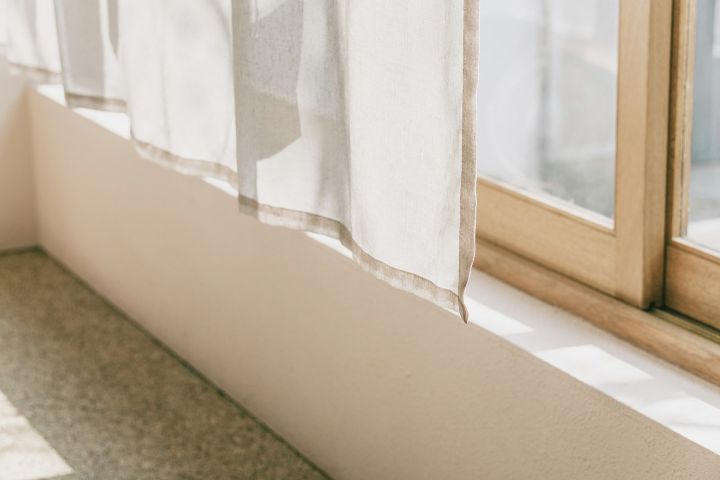 Sheer curtains in front of a sunlit window